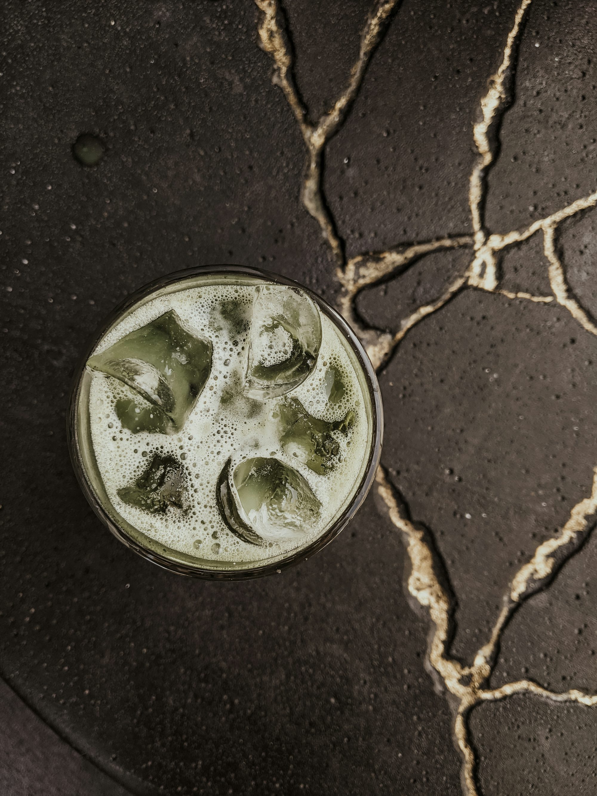 clear drinking glass with green liquid