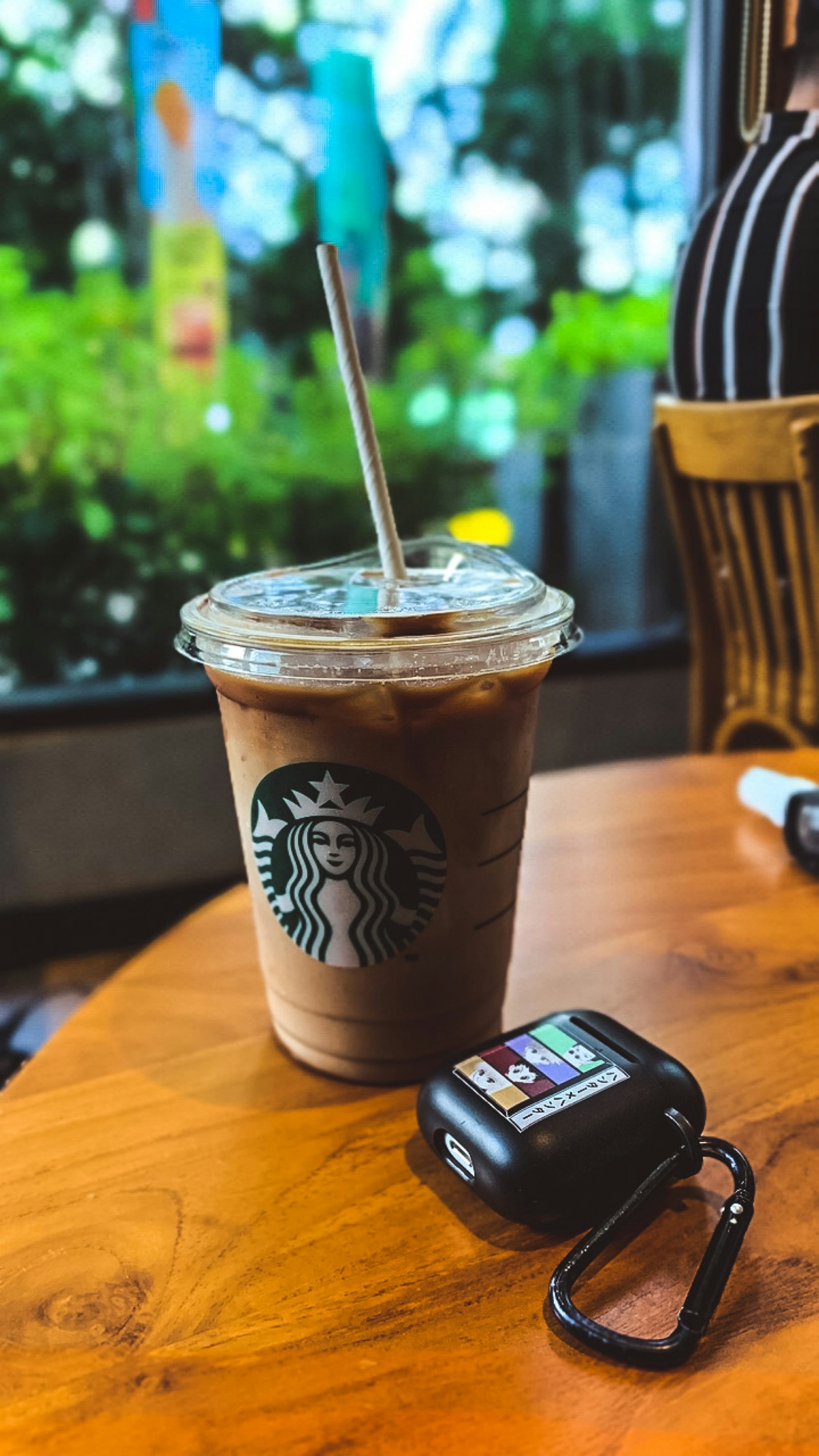 a cup of coffee and a cell phone on a table
